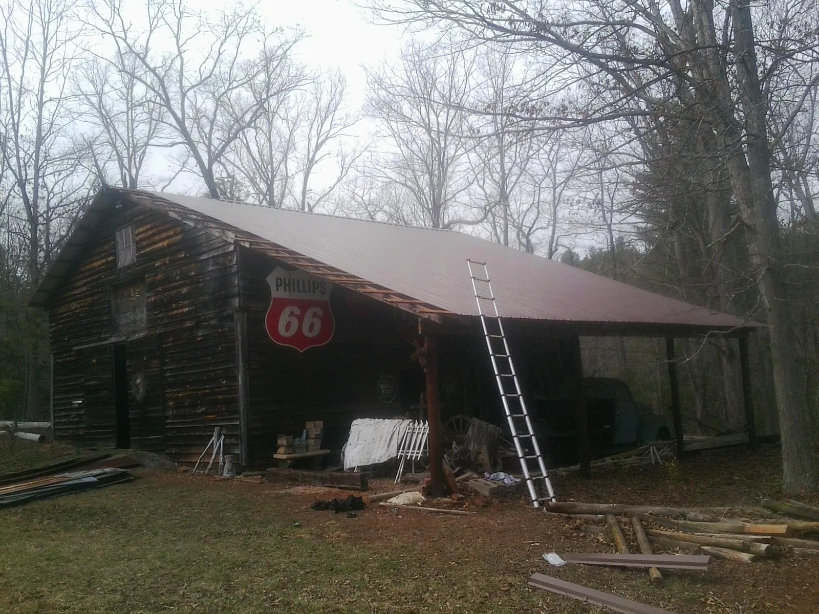 New metal roof on an open sided timber barn with a vintage sign in Vermilion