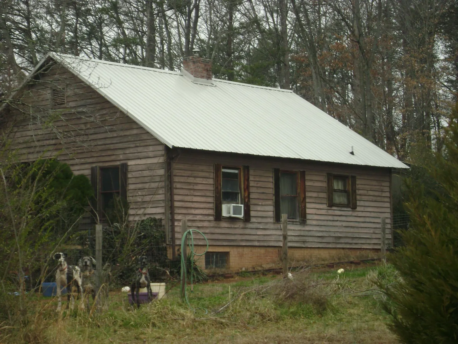 White metal roof on an old wood sided farmhouse, from a Metal Roof Installation job in Vermilion